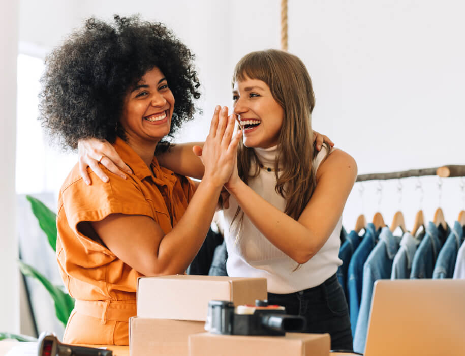 Two women high-fiving 