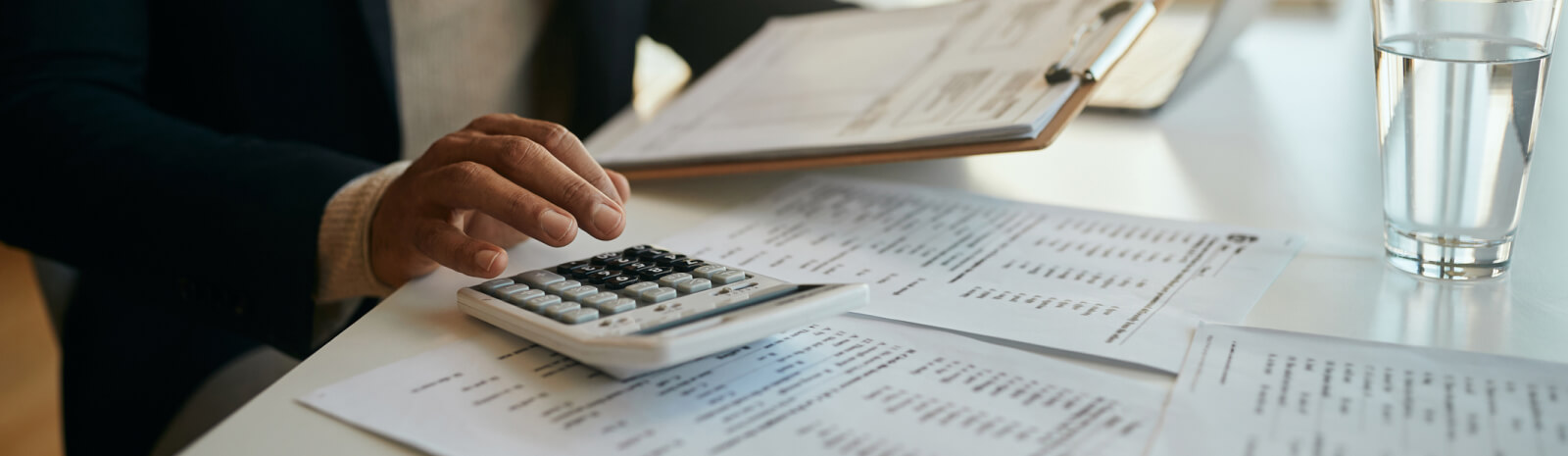 Close up of a hand using a calculator