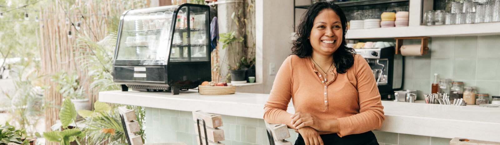 Woman seated at the bar of a cafe 