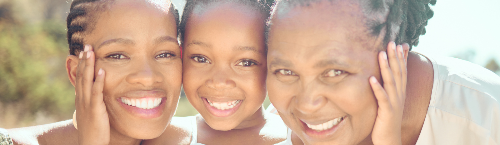 girl embracing her mother and grandmother