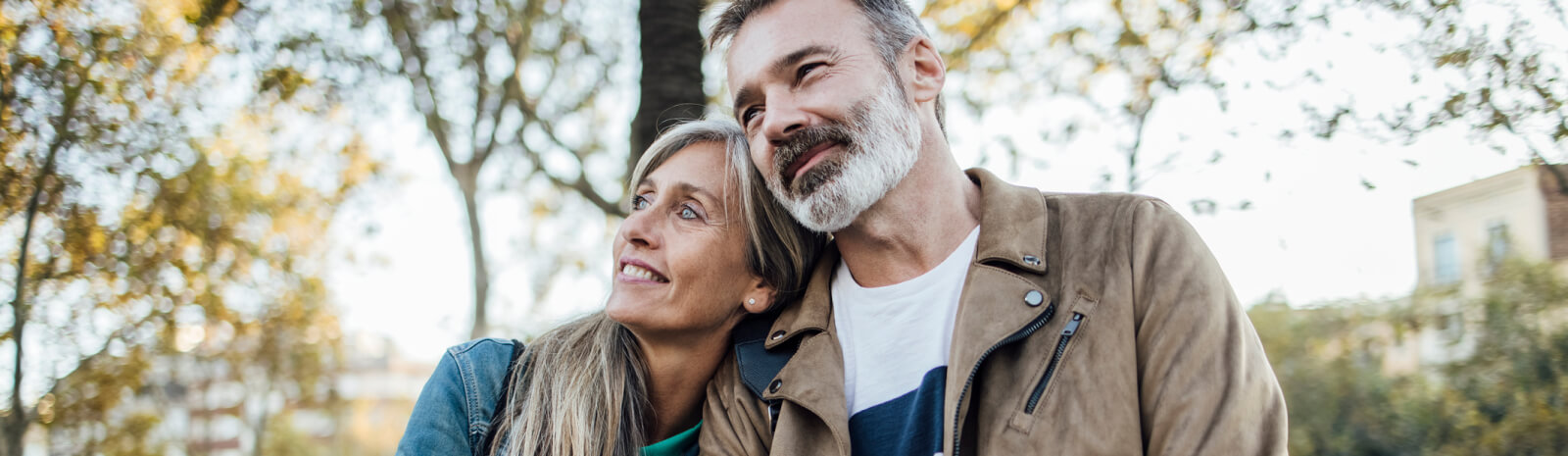 Couple leaning on each other in a park